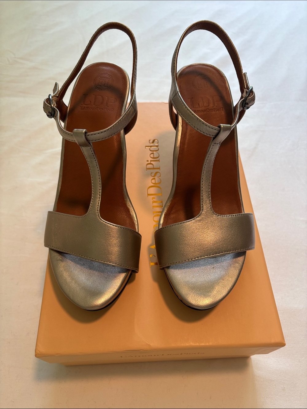 L’Amour Des Pieds Idelle Metallic Taupe T-Strap Wedge Sandals